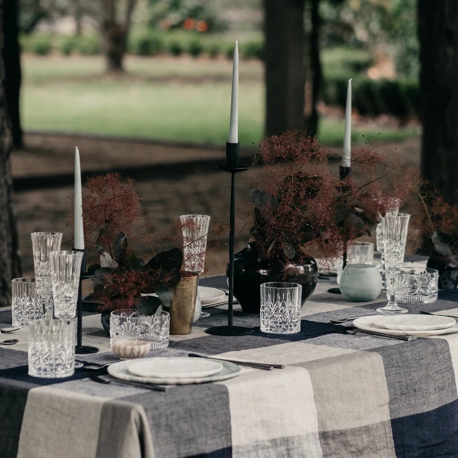 Atelier Black Iron Candle Stands x 3 with white pillar candles on dining table set outside - available at LOVINLIFE Co Byron Bay for all your gifts, candles and interior decorating needs
