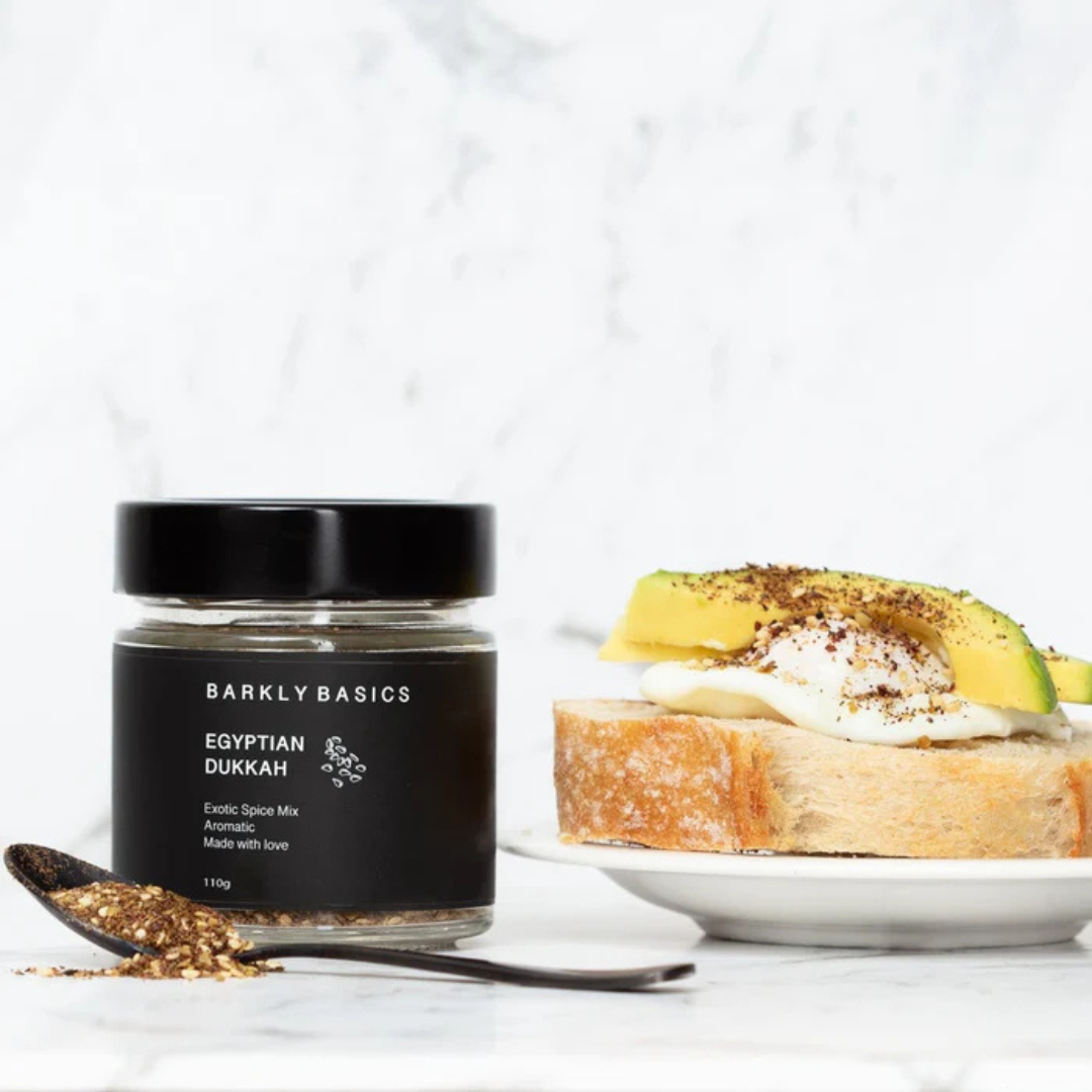 Jar of Barkly Basics Egyptian Dukkah with a dish of toast and avocado on a white background - available at LOVINLIFE Co Byron Bay for all your gifts, candles and interior decorating needs