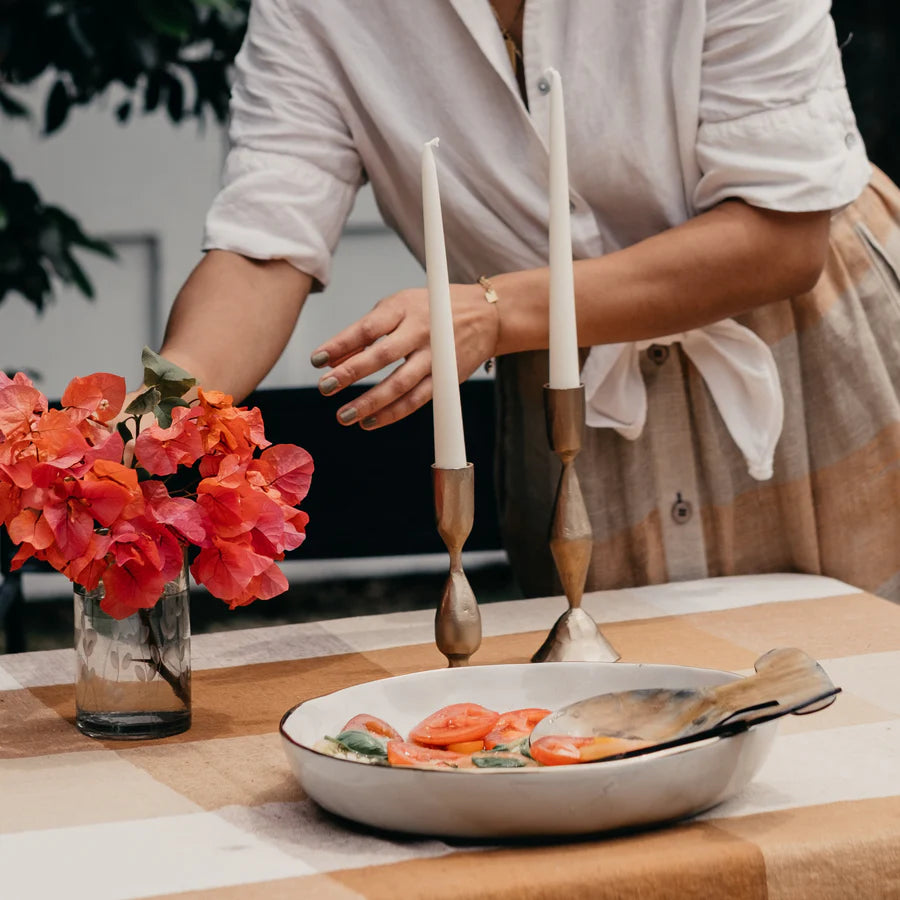 Belle Brass Candle Stands holding cream candles on a dinner table - available at LOVINLIFE Co Byron Bay for all your gifts, candles and interior decorating needs
