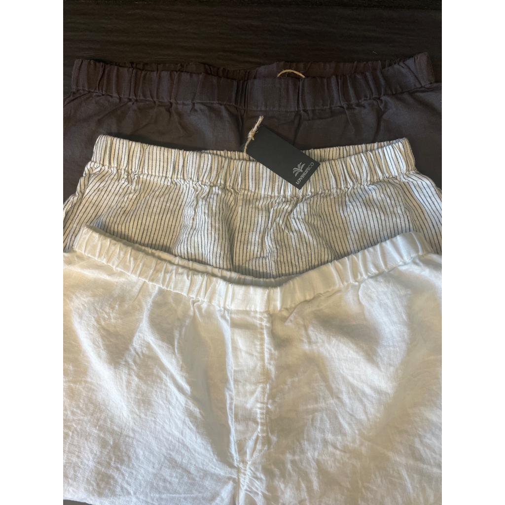 French flax linen unisex boxer shorts, loose, comfy and playful for men and women of all shapes and sizes - Available in 5 colours: White, Pinstripe, Natural, Navy & Charcoal – Navy, pinstripe and white linen boxer shorts pictured in a flat lay - available at LOVINLIFE Co Byron Bay for all your gifts, candles and interior decorating needs