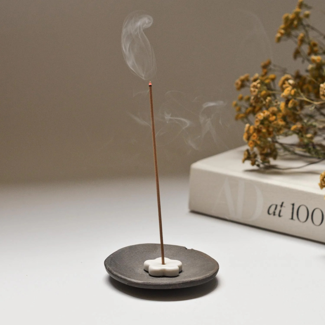 Incense Set - picture of a smoking incense stick standing in the holder, placed in a clay smudging bowl next to a book with dried flowers on top - Stocked at LOVINLIFE Co Byron Bay for all your gifts, candles and interior decorating needs