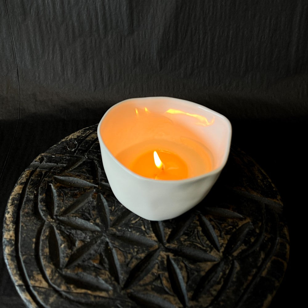 Lovinlife Co ByronBay - Signature Candle Range, also available for wholesale - Hand Made Candle in Re-usable ceramic bowl pictured alight, top view, on top of antique wooden serving plate