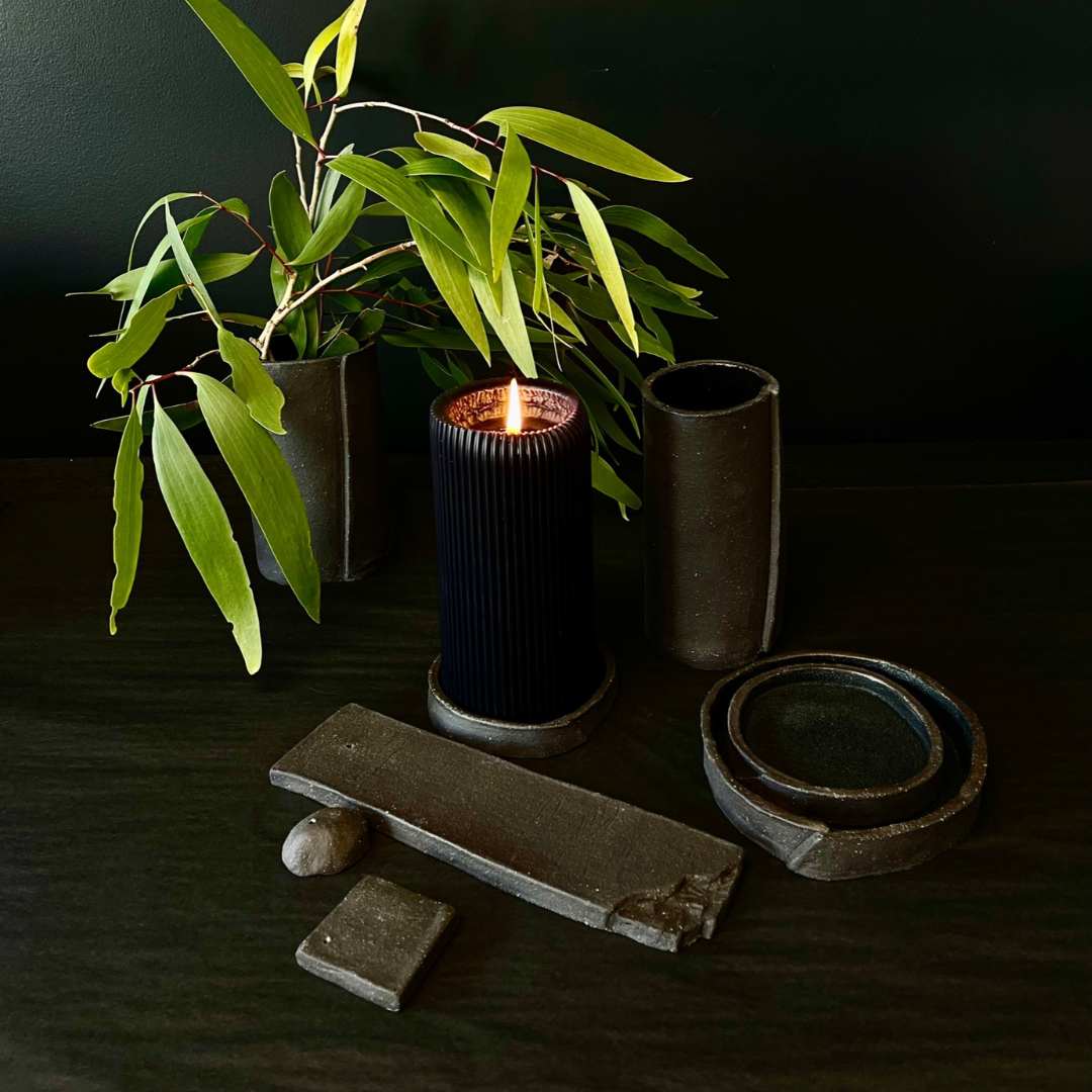 Lovinlife Co ByronBay - Handmade Signature Ceramics Range - Dark Matter Slab Series, matt black stone finish clay pieces - Incense Holders, Vases and smudging bowls and dishes pictured with ribbed black pillar candle and eucalyptus leaves - available at LOVINLIFE Co Byron Bay for all your gifts, candles and interior decorating needs