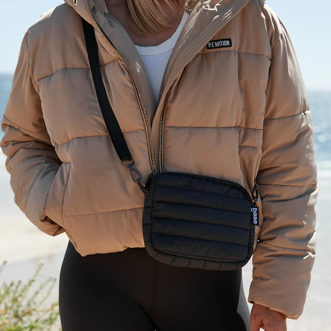 Mini Base Cloud Bag - a small crossbody bag in soft, cloud-like fabric - black bag pictured being worn across the body - Stocked at LOVINLIFE Co Byron Bay for all your gifts, candles and interior decorating needs