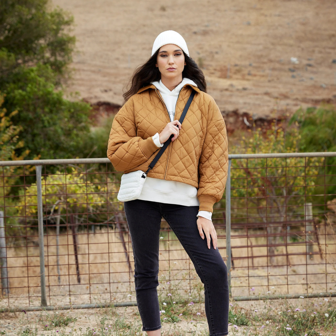 Mini Base Cloud Bag - a small crossbody bag in soft, cloud-like fabric - ecru white bag pictured being worn across the body- Stocked at LOVINLIFE Co Byron Bay for all your gifts, candles and interior decorating needs