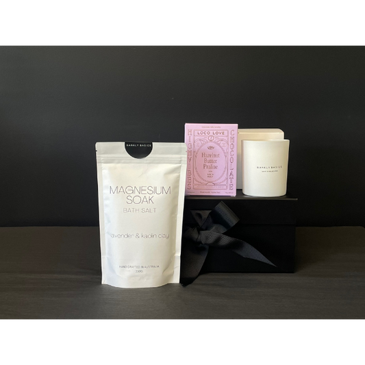 Mini Pamper Gift Box contents including Bath salt package labelled 'Magnesium Soak', a candle and twin box of Loco Love Chocolates. Available at LOVINLIFE Co Byron Bay