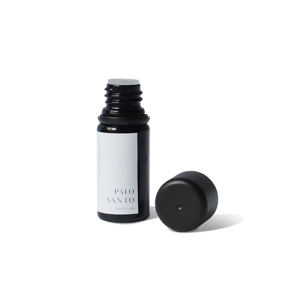 Essential Oil Palo Santo - A 100% pure essential oil blend, free from gluten, cruelty, parabens, and phthalates - bottle pictured with cap off - Stocked at LOVINLIFE Co Byron Bay for all your gifts, candles and interior decorating needs