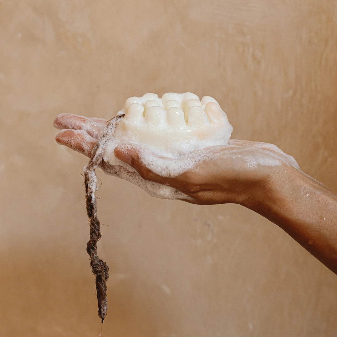 Palo Santo Bar Soap - white - picture of the soap on a rope resting in the palm of a hand with suds all over - Stocked at LOVINLIFE Co Byron Bay for all your gifts, candles and interior decorating needs