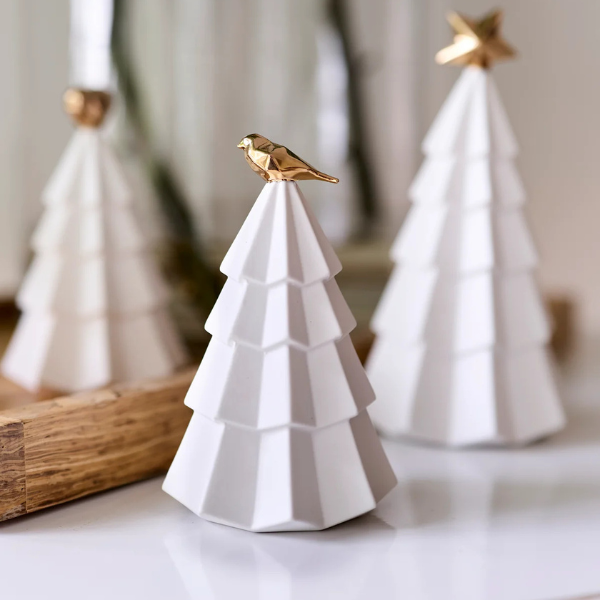 White ceramic Christmas tree with a gold bird ornament on a neutral background. Part of the Robert Gordon Collection stocked at LOVINLIFE Co Byron Bay for all your gifts, candles, homewares and interior decorating needs