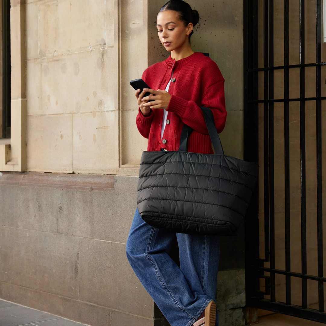 Take it Base Bag - A large soft-as-a-cloud shoulder bag for days on the go or weekends away - Black bag pictured being carried on forearm - Stocked at LOVINLIFE Co Byron Bay for all your gifts, candles and interior decorating needs