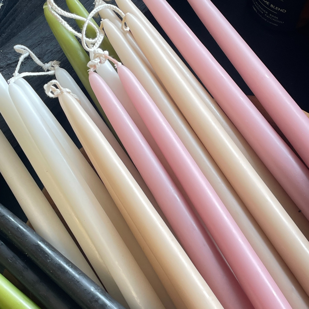 Pile of coloured Taper Candles, pink, cream, moonstone, white, green and black - available at LOVINLIFE Co Byron Bay for all your gifts, candles and interior decorating needs