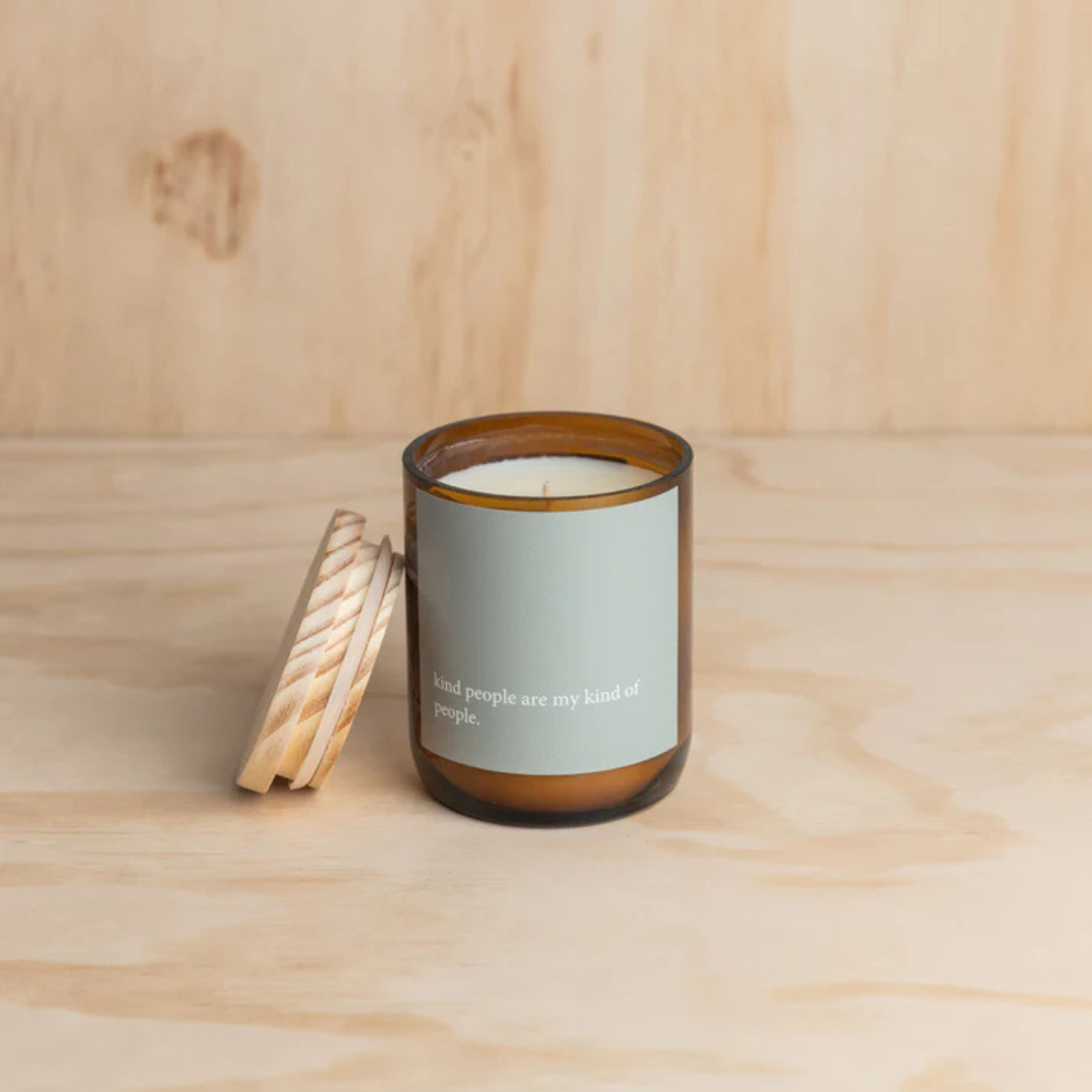 Commonfolk Heartfelt Candle - Tulum Scent with mango + lime - "Kind people are my kind of people" jar pictured on plywood backdrop with lid resting beside the jar - Stocked at LOVINLIFE Co Byron Bay for all your gifts, candles and interior decorating needs