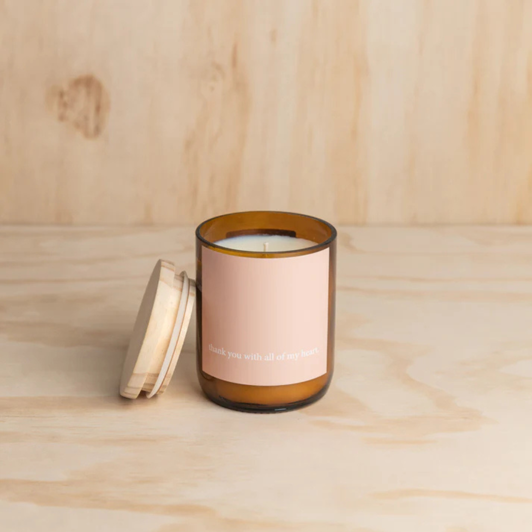 Commonfolk Heartfelt Candle - Palm Desert Scent with sandalwood + patchouli - "Thank you with all of my heart" jar pictured on plywood backdrop with lid off and resting beside the jar - Stocked at LOVINLIFE Co Byron Bay for all your gifts, candles and interior decorating needs