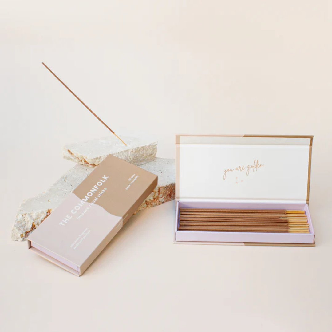 Commonfolk Incense Ritual Sticks - Palm Desert scent with Sandalwood and Patchouli - open box pictured next to closed box and stick being held in rock incense holder - Stocked at LOVINLIFE Co Byron Bay for all your gifts, candles and interior decorating needs