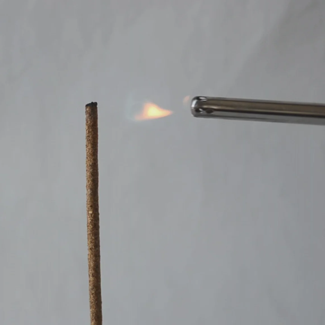 Cedar and Myrrh Lavender Flower Hand Rolled Incense Stick - pictured being lit - Stocked at LOVINLIFE Co Byron Bay for all your gifts, candles and interior decorating needs