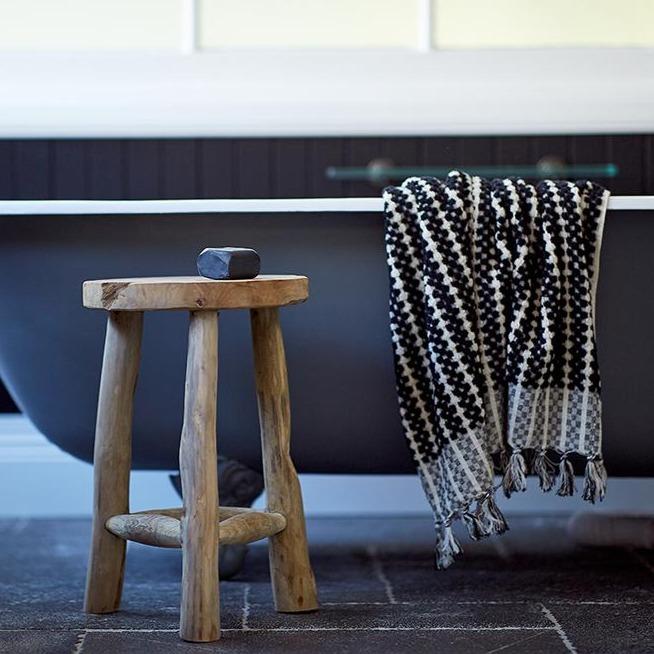 Lovinlife Co ByronBay – Saarde Charcoal Olive Oil Bar Soap – Activated Charcoal for deep cleaning, gentle exfoliation, absorbing excess oil - unscented – soap bar pictured resting on wooden stool next to claw foot bath with black and white towel draped over - available at LOVINLIFE Co Byron Bay for all your gifts, candles and interior decorating needs