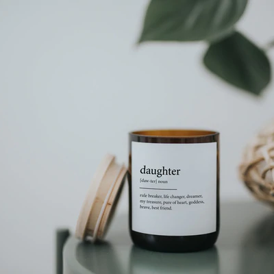 Commonfolk Dictionary Candle - Daughter - amber glass jar on table with wood lid off - Stocked at LOVINLIFE Co Byron Bay for all your gifts, candles and interior decorating needs
