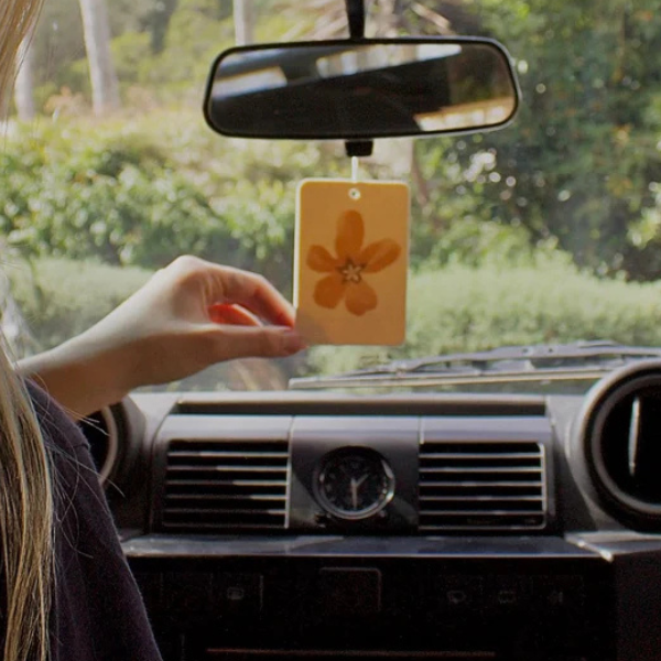 Flower Town design Air Freshener tags - Made from 100% post-consumer materials - BIARRITZ SCENT: jasmine, saffron + musk, Feel allured as you indulge in this poetic union that is luxe and luminous, yet grounding - Pictured hanging from rear vision mirror. Stocked at LOVINLIFE Co Byron Bay for all your gifts, candles and interior decorating needs