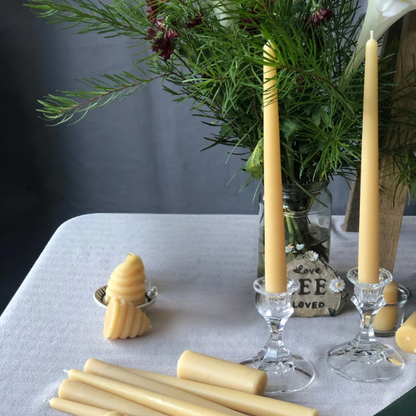 100% Pure Beeswax candles in various holders on a table with greenery in the background. Stocked at LOVINLIFE Co Byron Bay for all your gifts, candles and interior decorating needs