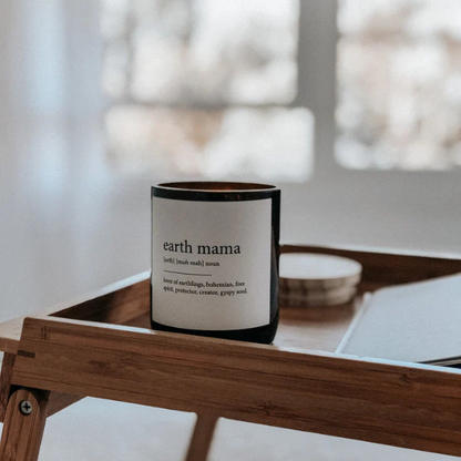 Candle labelled 'earth mama' on a wooden surface with a blurred background. These Dictionary Meaning Candles are one of our most loved products. We have spent an abundance of time, curating our own meanings of the words to help you feel connected, to help you tell someone how you feel in a unique way. Available at LOVINLIFE Co Byron Bay