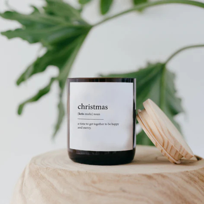 Candle labelled 'Christmas' on a wooden surface with green leaves in the background. These Dictionary Meaning Candles are some of our most loved products. We have spent an abundance of time, curating our own meanings of the words to help you feel connected, to help you tell someone how you feel in a unique way. Available at LOVINLIFE Co Byron Bay