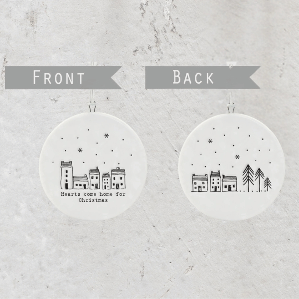 White, round porcelain Christmas decoration finished with simple hand-drawn style illustrations of houses and the  phrase “Hearts come home for Christmas”. Made by East of India in the UK, available at LOVINLIFE Co Byron Bay