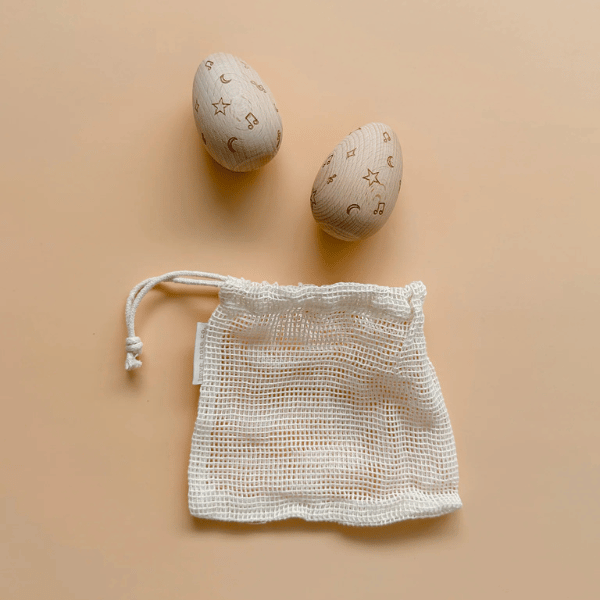 2 x wooden egg shakers and mesh drawstring carry bag by Love Note Co made with FSC certified Beechwood. All  instruments by Love Note Co are handmade items, non-toxic, eco-friendly and sustainably sourced. Stocked at LOVINLIFE Co Byron Bay for all your gifts, candles and interior decorating needs