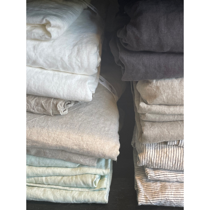 French flax linen sheets, prewashed and softened to sit gently against your skin – A selection of White, Natural, Charcoal, Grey, Green and Pinstripe French linen bed sheet pictured folded in store - available at LOVINLIFE Co Byron Bay for all your gifts, candles and interior decorating needs