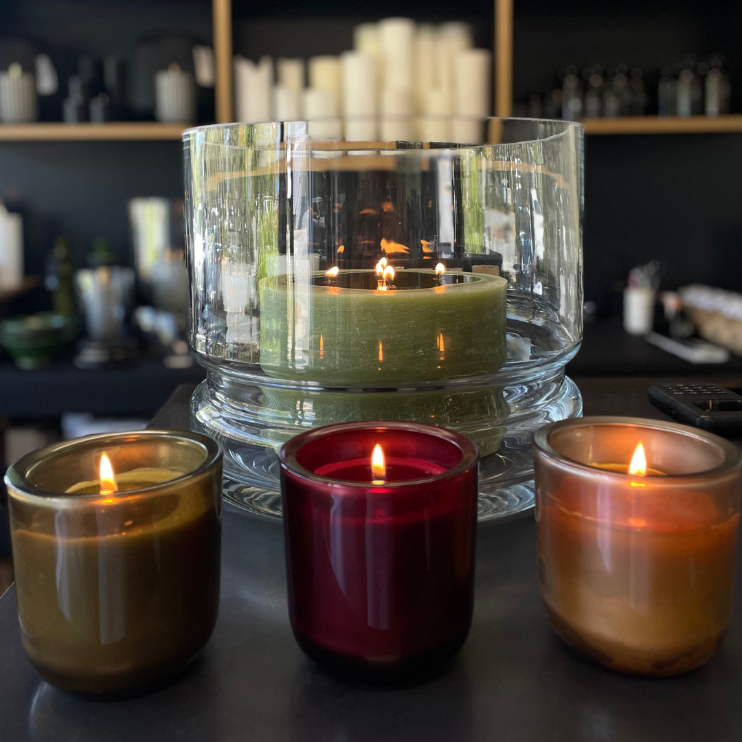 Glass Base Candle Holder / Vase from Francalia in Clear, pictured holding a large multi wick candle in khaki with 3 x coloured glass candles in front - Stocked at LOVINLIFE Co Byron Bay for all your gifts, candles and interior decorating needs