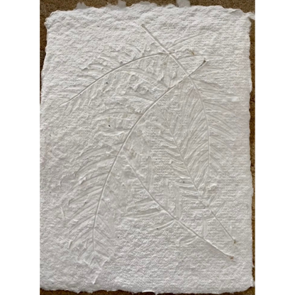 Flat lay close up of the texture of a Hand Pressed Paper A5 page in white, embossed with natural leaves. Stocked at LOVINLIFE Co Byron Bay for all your gifts, candles and interior decorating needs 