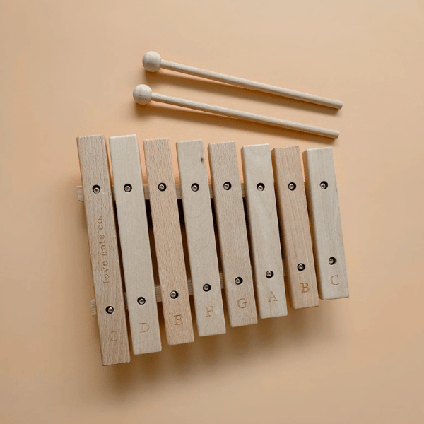 Little Noted Xylophone made with FSC certified Birch & Beechwood, and Metal. One of a kind hand-crafted and exclusively in house designed 8 key xylophone (x2 mallets & cotton canvas bag included). Made with Wood, iron and leather. All  instruments by Love Note Co are handmade items, non-toxic, eco-friendly and sustainably sourced. Stocked at LOVINLIFE Co Byron Bay for all your gifts, candles and interior decorating needs