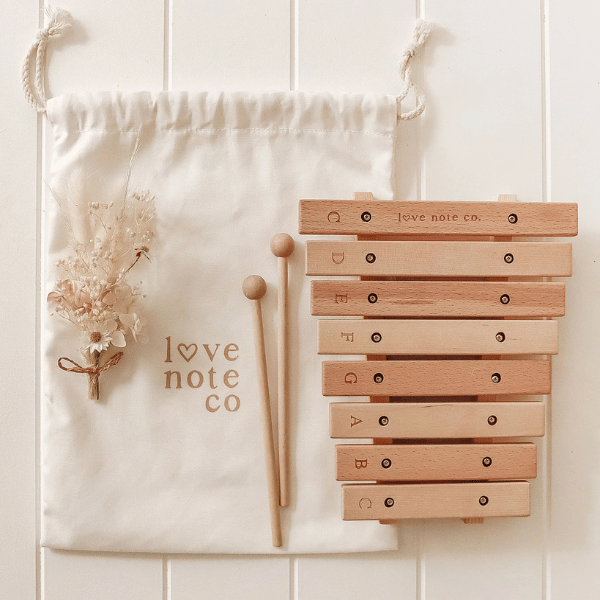 Little Noted Xylophone made with FSC certified Birch & Beechwood, and Metal. One of a kind hand-crafted and exclusively in house designed 8 key xylophone (x2 mallets & cotton canvas bag included). Made with Wood, iron and leather. All  instruments by Love Note Co are handmade items, non-toxic, eco-friendly and sustainably sourced. Stocked at LOVINLIFE Co Byron Bay for all your gifts, candles and interior decorating needs