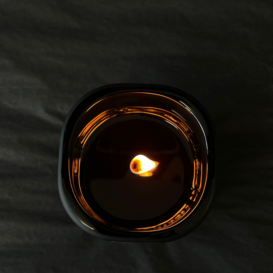 Lovinlife Co ByronBay - Signature Candle Range, also available for wholesale - Unisex Black Candle pictured alight from above - Red Apple, Black Pepper, Tobacco, Tonka Bean & Patchouli scent profile - available at LOVINLIFE Co Byron Bay for all your gifts, candles and interior decorating needs