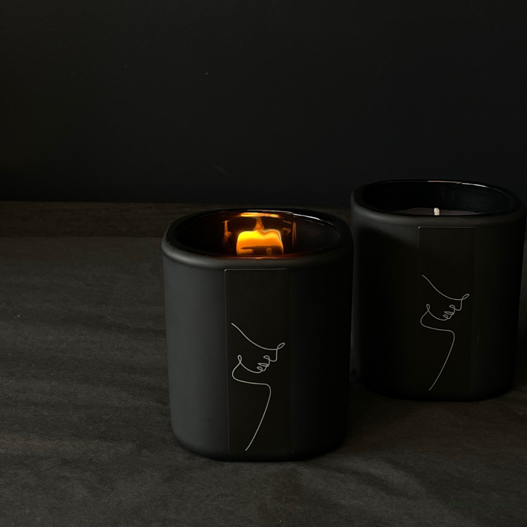 Lovinlife Co ByronBay - Signature Candle Range, also available for wholesale - 2 xUnisex Black Candles pictured alight on black background - Red Apple, Black Pepper, Tobacco, Tonka Bean & Patchouli scent profile - available at LOVINLIFE Co Byron Bay for all your gifts, candles and interior decorating needs