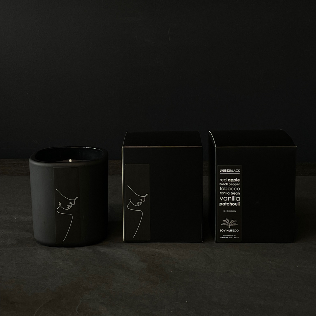 Lovinlife Co ByronBay - Signature Candle Range, also available for wholesale - Unisex Black Candle pictured next to box on black background - Red Apple, Black Pepper, Tobacco, Tonka Bean & Patchouli scent profile - available at LOVINLIFE Co Byron Bay for all your gifts, candles and interior decorating needs