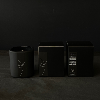 Lovinlife Co ByronBay - Signature Candle Range, also available for wholesale - Unisex Black Candle pictured next to box on black background - Red Apple, Black Pepper, Tobacco, Tonka Bean & Patchouli scent profile - available at LOVINLIFE Co Byron Bay for all your gifts, candles and interior decorating needs