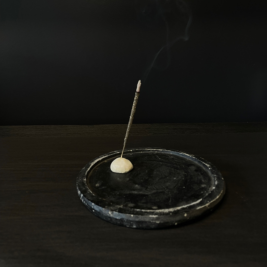 Lovinlife Co ByronBay – handmade Ceramic Pebble Incense Holder to hold your favourite incense – pictured holding incense stick on vintage black wooden board - available at LOVINLIFE Co Byron Bay for all your gifts, candles and interior decorating needs