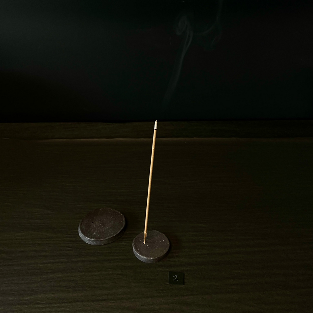 Lovinlife Co ByronBay - Handmade Signature Ceramics Range - Dark Matter Slab Series, matt black stone finish clay pieces - 2 x Round Flat Incense Holders pictured, one holding a smoking incense stick - available at LOVINLIFE Co Byron Bay for all your gifts, candles and interior decorating needs