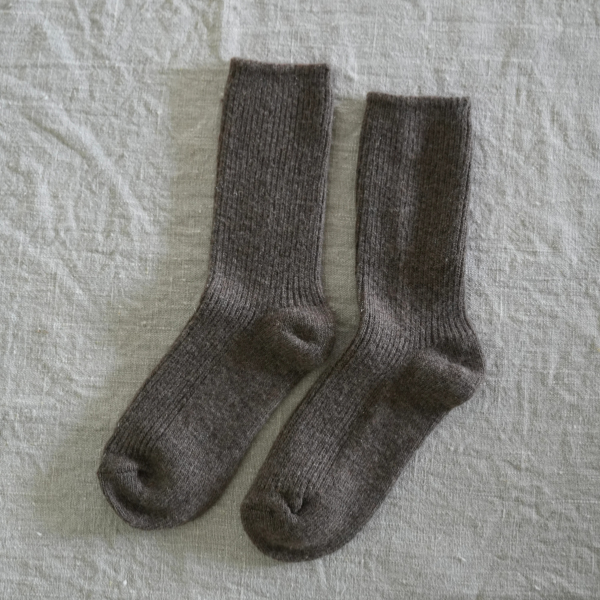 Pair of Chocolate coloured socks flat lay on a linen background. Luxe Cashmere Blend Socks by Number Thirty One made with a premium blend of cashmere and wool. Unisex & One size. Stocked at LOVINLIFE Co Byron Bay for all your gifts, candles and interior decorating needs