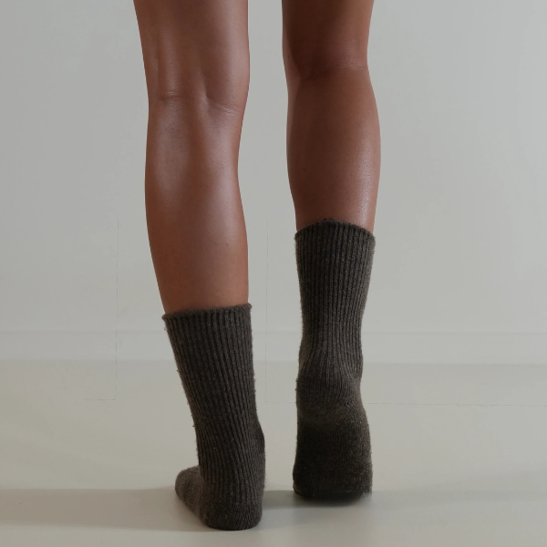 Chocolate coloured socks on a person’s feet, back view, on a plain background. Luxe Cashmere Blend Socks by Number Thirty One made with a premium blend of cashmere and wool. Unisex & One size. Stocked at LOVINLIFE Co Byron Bay for all your gifts, candles and interior decorating needs