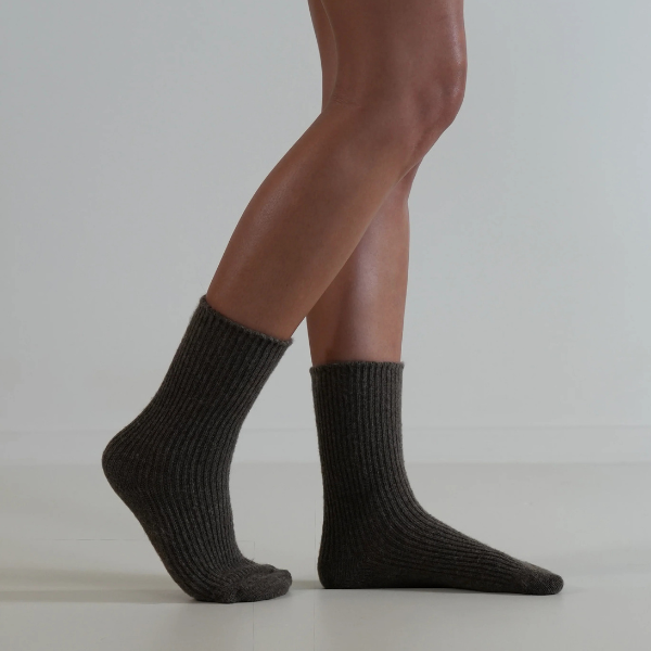 Chocolate coloured socks on a person’s feet, side view, on a plain background. Luxe Cashmere Blend Socks by Number Thirty One made with a premium blend of cashmere and wool. Unisex & One size. Stocked at LOVINLIFE Co Byron Bay for all your gifts, candles and interior decorating needs