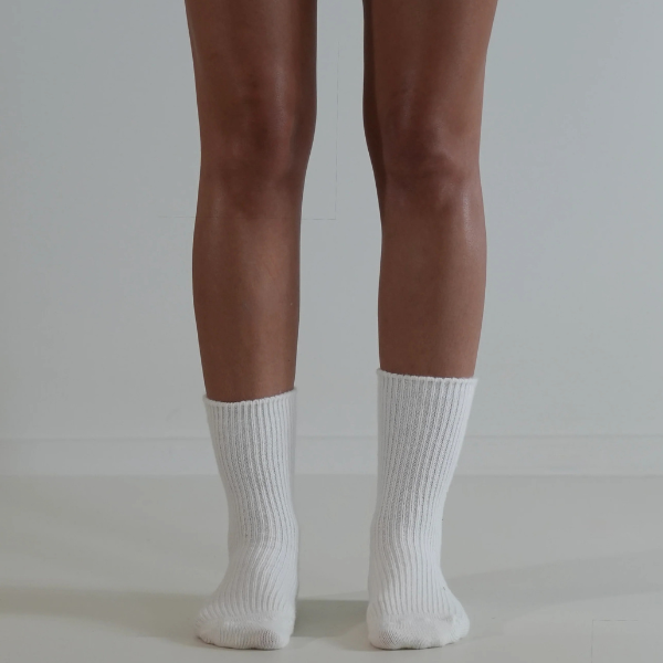 Milk coloured socks on a person’s feet, front view, on a plain background. Luxe Cashmere Blend Socks by Number Thirty One made with a premium blend of cashmere and wool. Unisex & One size. Stocked at LOVINLIFE Co Byron Bay for all your gifts, candles and interior decorating needs
