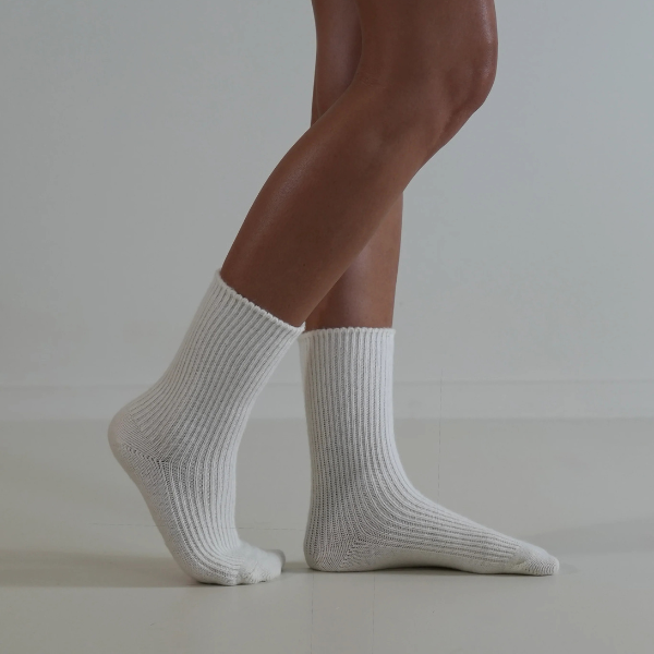 Milk coloured socks on a person’s feet, side view, on a plain background. Luxe Cashmere Blend Socks by Number Thirty One made with a premium blend of cashmere and wool. Unisex & One size. Stocked at LOVINLIFE Co Byron Bay for all your gifts, candles and interior decorating needs