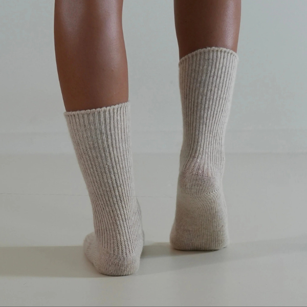 Natural coloured socks on a person’s feet, back view, on a plain background. Luxe Cashmere Blend Socks by Number Thirty One made with a premium blend of cashmere and wool. Unisex & One size. Stocked at LOVINLIFE Co Byron Bay for all your gifts, candles and interior decorating needs