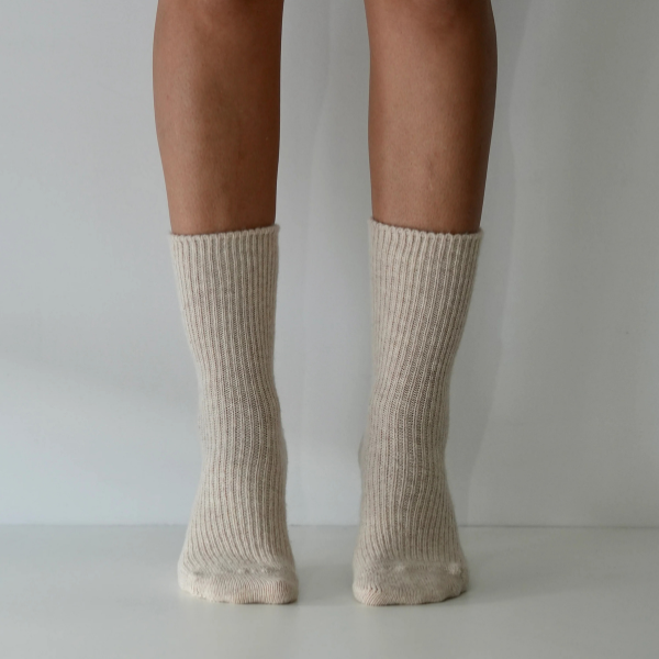 Natural coloured socks on a person’s feet, front view, on a plain background. Luxe Cashmere Blend Socks by Number Thirty One made with a premium blend of cashmere and wool. Unisex & One size. Stocked at LOVINLIFE Co Byron Bay for all your gifts, candles and interior decorating needs