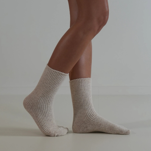 Natural coloured socks on a person’s feet, side view, on a plain background. Luxe Cashmere Blend Socks by Number Thirty One made with a premium blend of cashmere and wool. Unisex & One size. Stocked at LOVINLIFE Co Byron Bay for all your gifts, candles and interior decorating needs