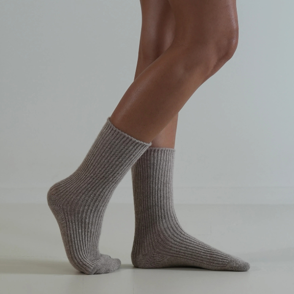 Taupe coloured socks on a person’s feet, side view, on a plain background. Luxe Cashmere Blend Socks by Number Thirty One made with a premium blend of cashmere and wool. Unisex & One size. Stocked at LOVINLIFE Co Byron Bay for all your gifts, candles and interior decorating needs