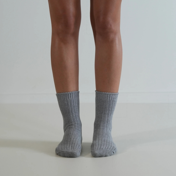 Grey socks on a person’s feet, front view, on a plain background. Luxe Cotton Socks by Number Thirty One made with a soft cotton, wool, and spandex blend. Unisex & One size. Stocked at LOVINLIFE Co Byron Bay for all your gifts, candles and interior decorating needs
