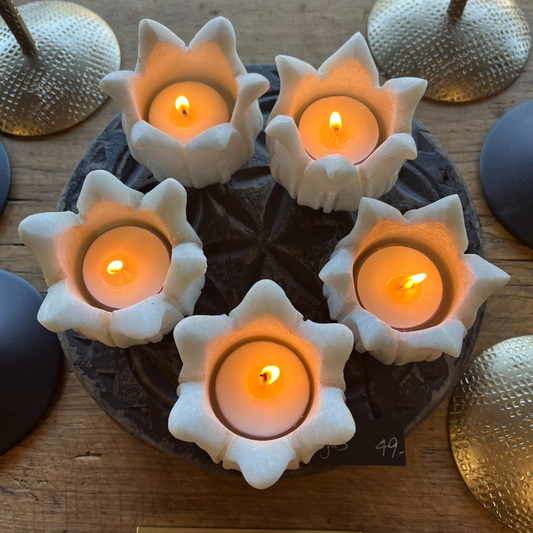 Indigo Love Marble Lotus Tea Light Holders - top view of collection of lotus holders with buring tealight candles inside each - solid natural marble hand-carved into the shape of a lotus - tea light candle holders - Tabletop Candle Holders Stocked at LOVINLIFE Co Byron Bay for all your gifts, candles and interior decorating needs