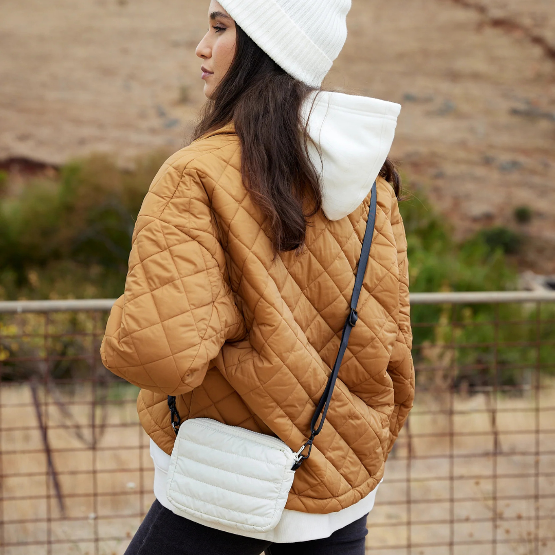 Mini Base Cloud Bag - a small crossbody bag in soft, cloud-like fabric - ecru white bag pictured being worn across the body, back view- Stocked at LOVINLIFE Co Byron Bay for all your gifts, candles and interior decorating needs